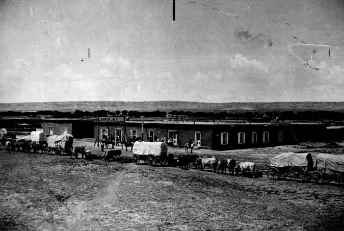 Wagon trains travel through what is now Belen in 1877 (From BNSF photo archives).