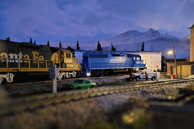 A blue BNSF locomotive railfans call the “Smurf” and Santa Fe “Yellow Bonnet” make an early night service stop.