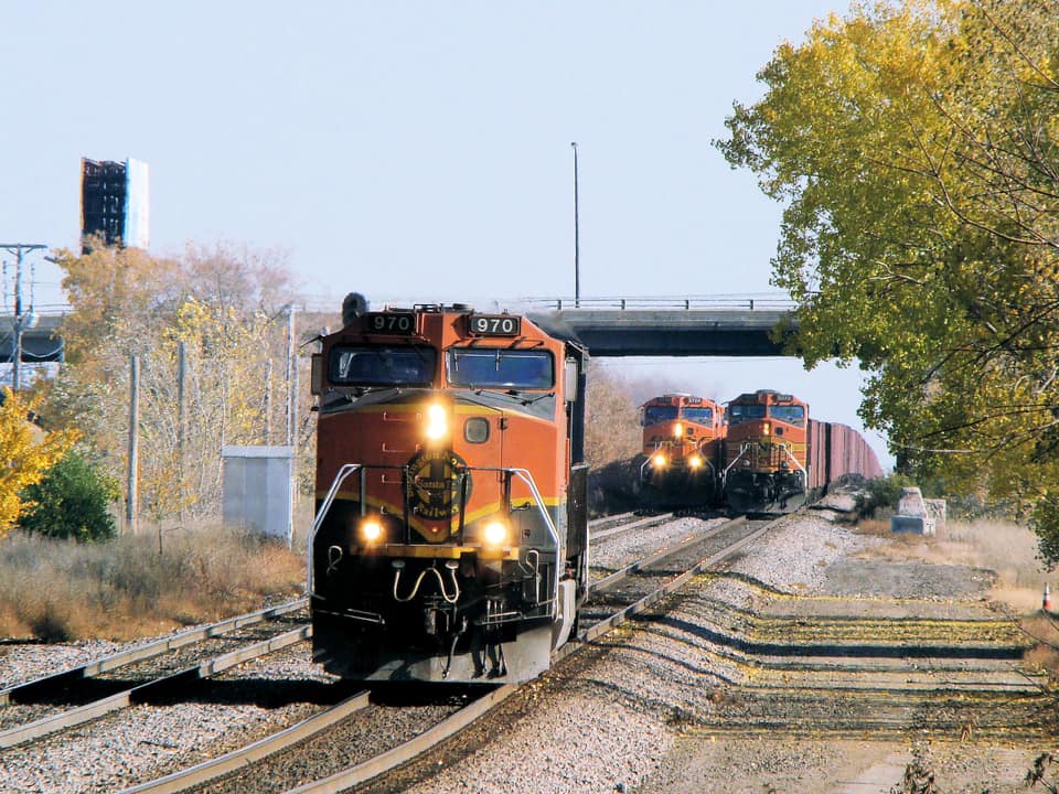 Three BNSF locomotives in three iconic paint schemes leaving St. Paul