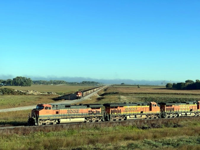 A BNSF train waits while another passes by at the completed bypass.