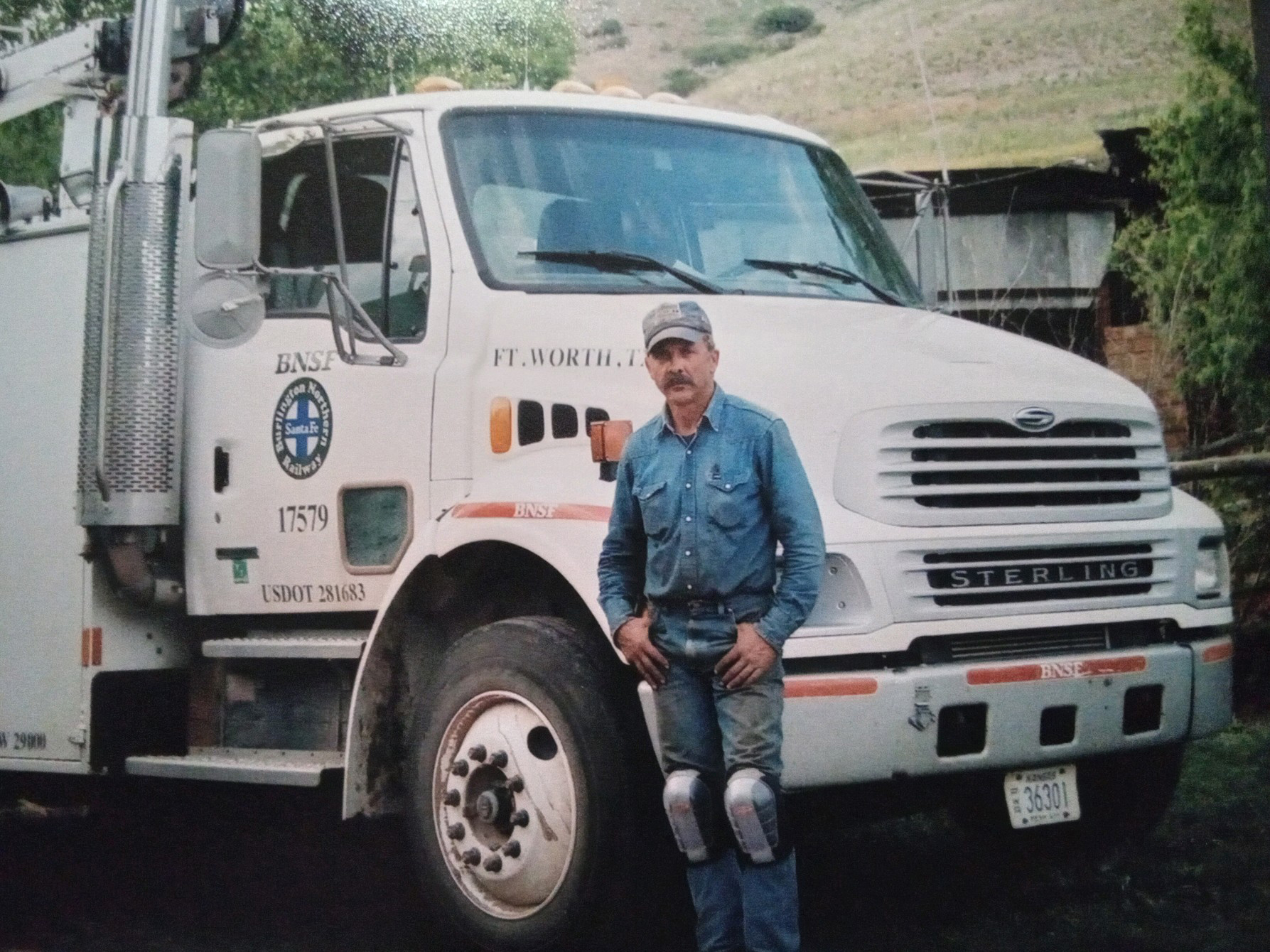 Greg Hampson standing in front of a BNSF vehicle in 2004
