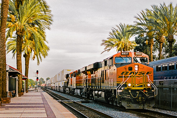 A train loaded with consumer goods heads out in California. 