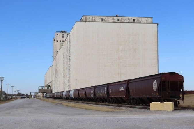 BNSF Train cars being filled by grain from one of the Enid Grain Elevators