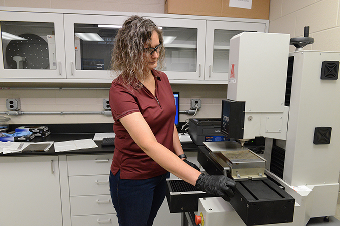 Engineer II Alicia Lollar is performing hardness measurements on a rail and electric flash butt weld sample. A slice was cut out and prepped so hardness readings could be taken across the sample.